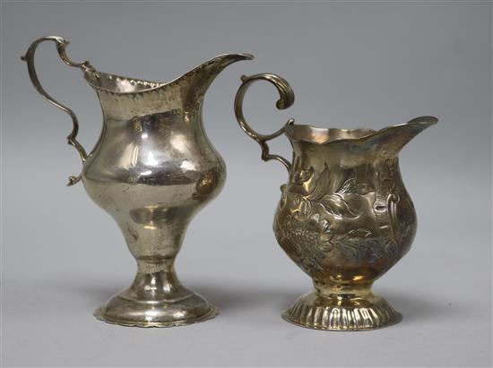 Two George III silver cream jugs, one by WK, London, 1766, tallest 12cm.
